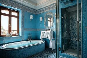 A stunning blue bathroom with a freestanding bathtub, walk-in shower, and double sinks. The bathtub is positioned in the center of the room, with a large window behind it that lets in natural light photo