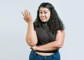 Puzzled woman gesturing with hand isolated. Girl with puzzled face frowning. Puzzled people making hand gestures photo