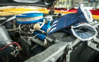 Protection Gloves Laying Next to Classic Car Engine Compartment photo