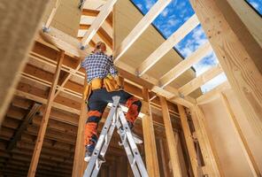 Contractor Worker Inside Newly Built Wooden House Frame Finishing Some Elements photo