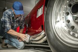 Classic Cars Mechanic Cleaning Part of the Car Muffler. photo