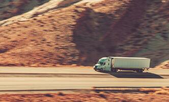 Speeding American Semi Truck on the Utahs Interstate High 70 photo