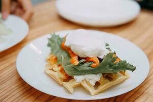 Viennese waffles with greens, salmon and poached egg, Breakfast at the cooking class. Delicious and healthy Breakfast. photo