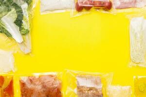 Hands holding bags of food. A set for delivering food for dinner on a yellow background. photo