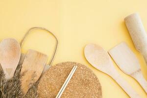 A set of eco-friendly bamboo Cutlery on yellow background. Concept of a waste-free lifestyle. Zero waste home. photo