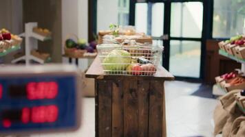 Empty local zero waste eco store having locally grown fruits and vegetables in crates, pasta or sauces stored in reusable glass containers on display. Organic supermarket merchandise. video