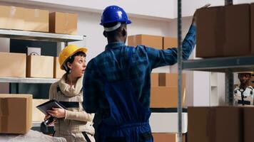 Man and woman scanning goods in warehouse depot, using digital tablet and scanner to scan barcodes and inventory for products. Team of workers planning stock logistics, industrial service. photo