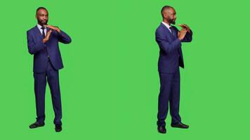 Company worker showing timeout pause gesture on camera posing over full body greenscreen. Young businessman expressing rejection and denial symbol, break sign in disagreement. photo