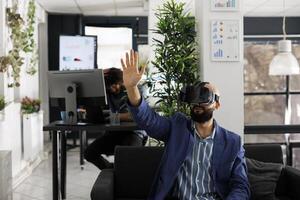 Business worker using vr technology for project presentation in startup company workplace. Entrepreneur wearing virtual reality headset to simulate product design and development photo