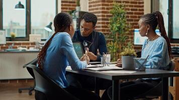 Business partners creating presentation in boardroom, looking at annual report plans on documents. Corporate workers doing teamwork meeting in offce, examining analytics results. photo