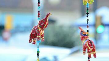 Red Indian elephants hanging in hawker stall craft video