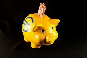 A piggy bank on black background photo