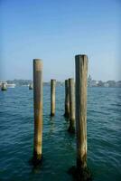 Wooden poles in the sea photo