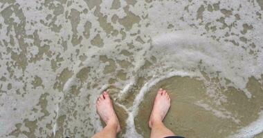 bare feet are washed by the waves of the sea or ocean. finally some rest and relaxation video