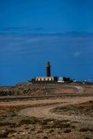 path to a lighthouse on a hill photo