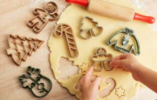 para niños manos con pan de jengibre galletas en de madera antecedentes foto