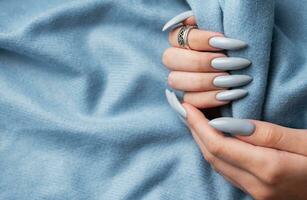 Blue manicure nails with a blue scarf photo