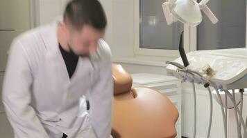 Doctor sits near dentist chair video