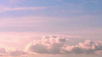 Beautiful fabulous pink cumulus clouds in the blue sky at sunset. natural background photo