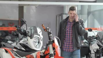 Consultant talks on the phone at motorbike salon video