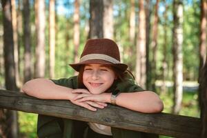 Cute girl in suit and hat in nature photo