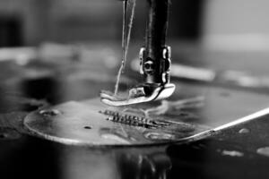 Vintage Black and White Close up Sewing machine and thread, vintage black and white concept photo