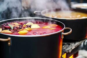 Beverages fruits and berries hot mulled wine in pots with steam in street food market. Generative AI photo