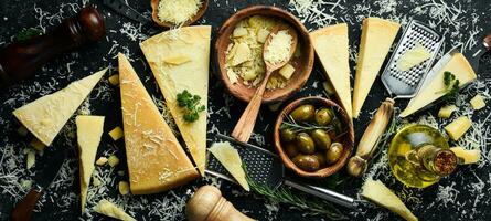 Piece of Parmesan cheese and cheese knife. On a stone background. Traditional Italian cheese. Top view. Free space for your text. photo