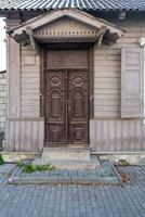 wooden doors to an old brick building photo