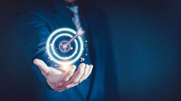 Businessman gesture protecting virtual blue dartboard with arrow ,Business Achievement objective target concept. photo