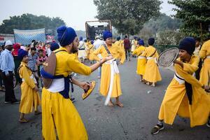 Delhi, India, October 2, 2023 - Sikhs display gatka and martial arts during annual Nagar Kirtan, Traditional, procession on account of birthday of Guru Nanak Dev ji, Nagar Kirtan in East Delhi area photo