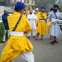 Delhi, India, October 2, 2023 - Sikhs display gatka and martial arts during annual Nagar Kirtan, Traditional, procession on account of birthday of Guru Nanak Dev ji, Nagar Kirtan in East Delhi area photo