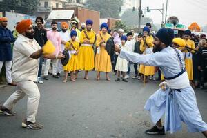 Delhi, India, October 2, 2023 - Sikhs display gatka and martial arts during annual Nagar Kirtan, Traditional, procession on account of birthday of Guru Nanak Dev ji, Nagar Kirtan in East Delhi area photo