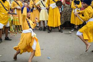 Delhi, India, October 2, 2023 - Sikhs display gatka and martial arts during annual Nagar Kirtan, Traditional, procession on account of birthday of Guru Nanak Dev ji, Nagar Kirtan in East Delhi area photo