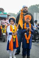 Delhi, India, October 2, 2023 - Sikhs display gatka and martial arts during annual Nagar Kirtan, Traditional, procession on account of birthday of Guru Nanak Dev ji, Nagar Kirtan in East Delhi area photo