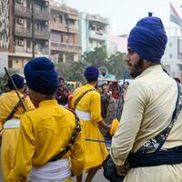 Delhi, India, October 2, 2023 - Sikhs display gatka and martial arts during annual Nagar Kirtan, Traditional, procession on account of birthday of Guru Nanak Dev ji, Nagar Kirtan in East Delhi area photo