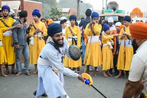 Delhi, India, October 2, 2023 - Sikhs display gatka and martial arts during annual Nagar Kirtan, Traditional, procession on account of birthday of Guru Nanak Dev ji, Nagar Kirtan in East Delhi area photo