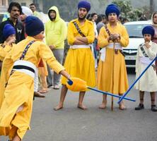 Delhi, India, October 2, 2023 - Sikhs display gatka and martial arts during annual Nagar Kirtan, Traditional, procession on account of birthday of Guru Nanak Dev ji, Nagar Kirtan in East Delhi area photo