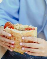 A young person enjoying a beef sandwich photo