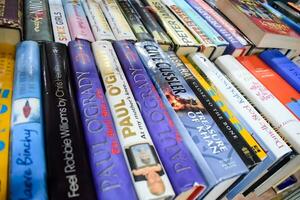 New Delhi, India, September 09 2023 - Variety of Books on shelf inside a book-stall at Delhi International Book Fair, Selection of books on display in Annual Book Fair. photo