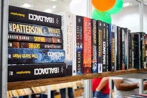 New Delhi, India, September 09 2023 - Variety of Books on shelf inside a book-stall at Delhi International Book Fair, Selection of books on display in Annual Book Fair. photo