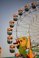 Closeup of multi-coloured Giant Wheel during Dussehra Mela in Delhi, India. Bottom view of Giant Wheel swing. Ferriswheel with colourful cabins during day time. photo