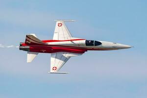 Swiss Air Force F-5E Tiger fighter jet plane flying. Aviation and military aircraft. Patrouille Suisse aerobatic team. photo