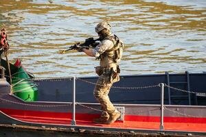 Hungarian Defence Forces. Spec Ops soldier with carbine. Counter terrorism. Military unit. Special operation on the water with boat. photo