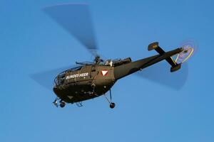 Austrian Air Force Aerospatiale Alouette III. Military transport helicopter at air base. Aviation and rotorcraft. Transport and airlift. Military industry. Fly and flying. photo