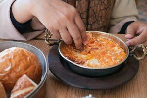 Turkish Menemen omelet in a frying pan. . photo