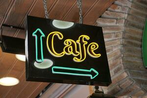 Glowing neon sign with words cafe . photo