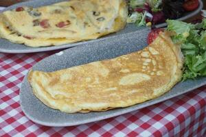 Plain Egg Omelette on breakfast table photo