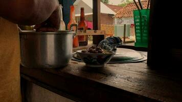 Preparing chicken noodles. View of a penjual mie ayam or chicken noodle seller who is making chicken noodles for the buyer. Selective focus. video