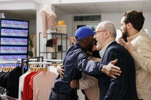 Black Friday fight between security guard and crazy crowd at clothes shop entrance. Eager shoppers lined up in department store, waiting for sales, police officer holding back people customers photo